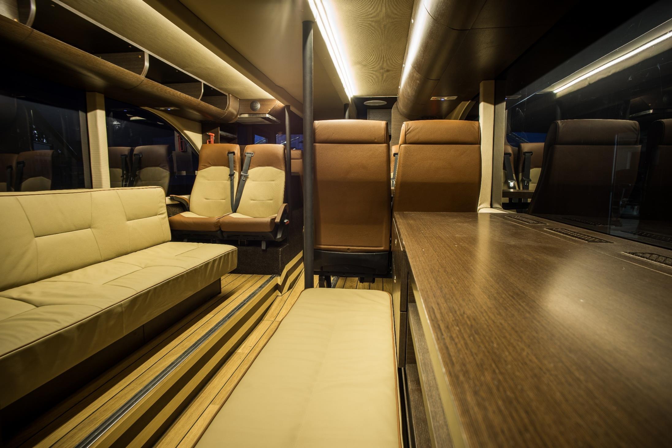 Upper deck lounge and seating area of the team bus