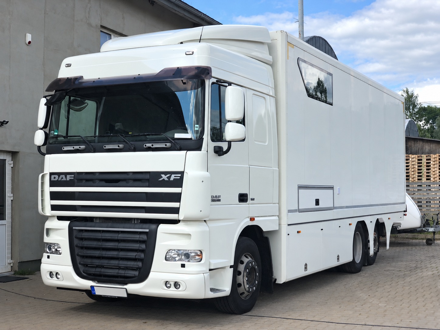 DAF XF 105.410 race transporter parked outside the workshop